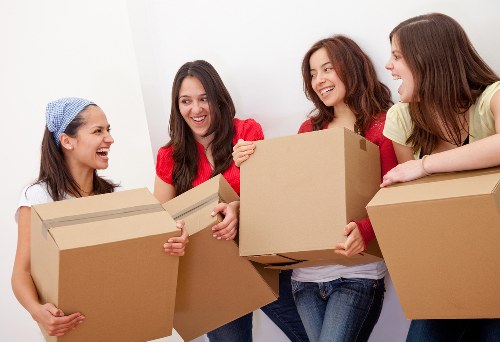 Professional movers handling boxes during a house move in Earlsfield
