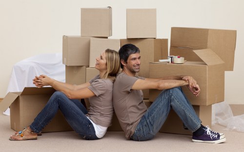 Two movers carrying a sofa during a man and van job in Earlsfield